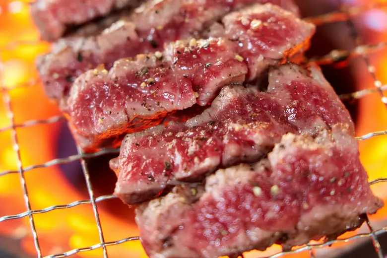 Skewers grilling over charcoal at a stall.